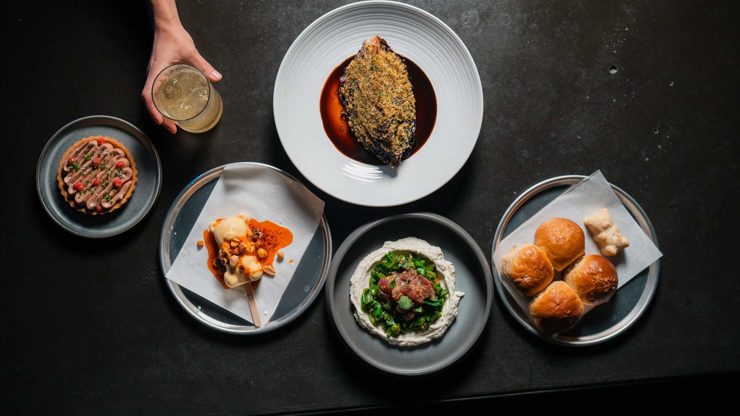 Overhead view of shared plates at BearLeek, a globally inspired restaurant in RiNo, Denver