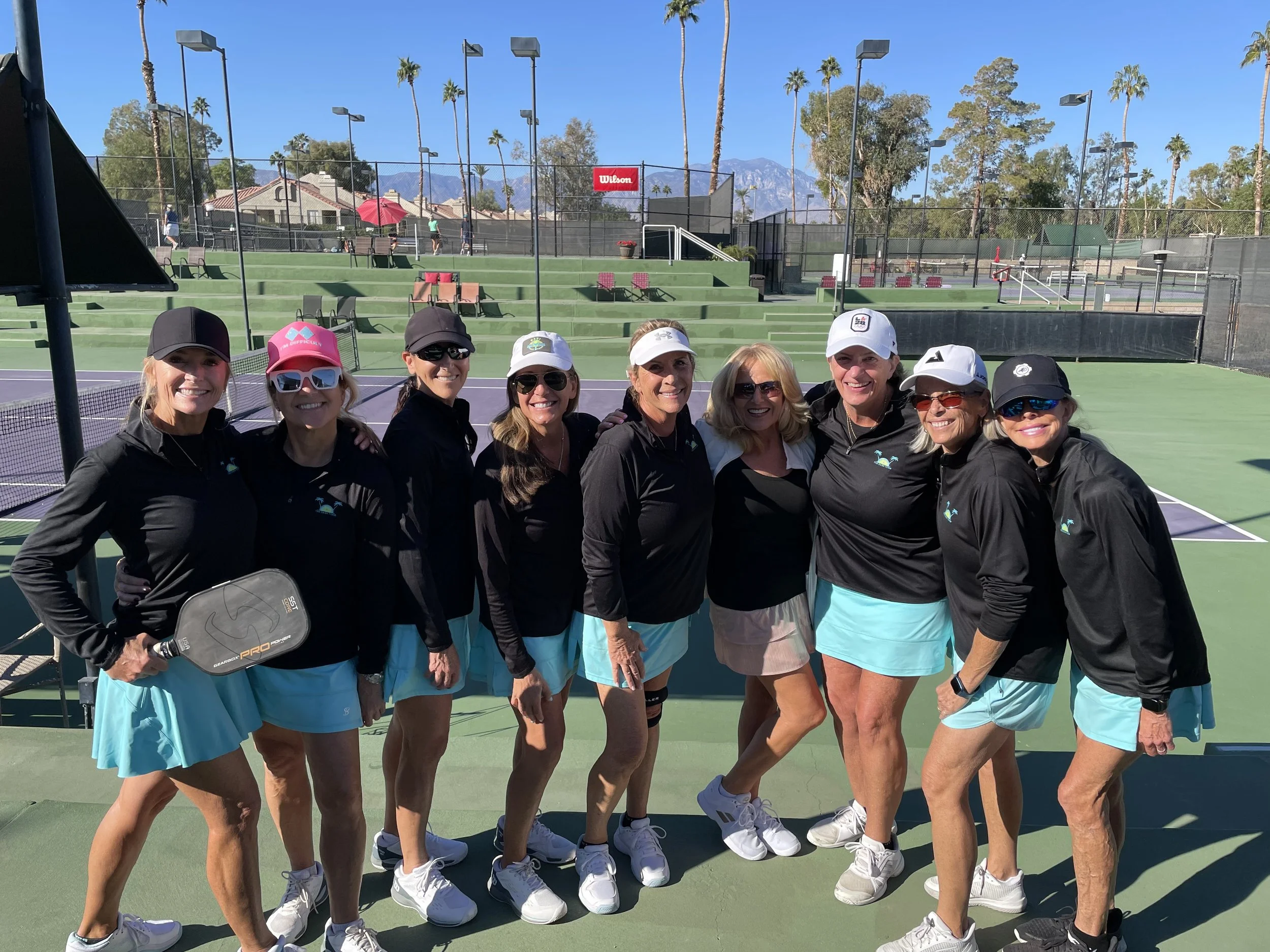 Pickleball women gathered for a group photo in matching uniform.