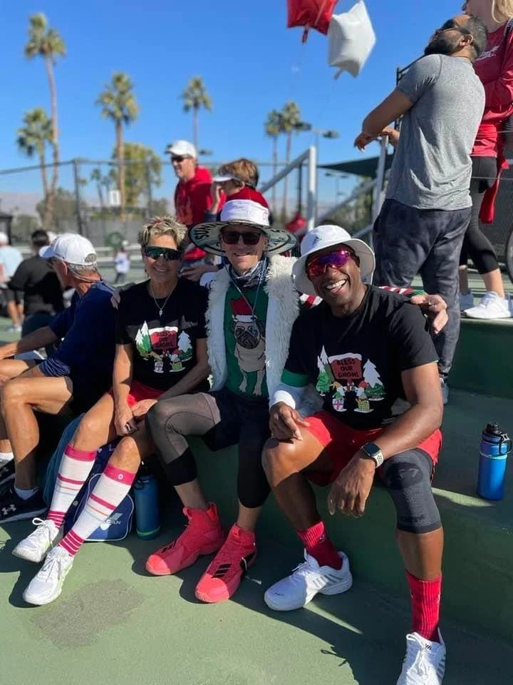 People taking a photo with ugly Christmas sweaters.