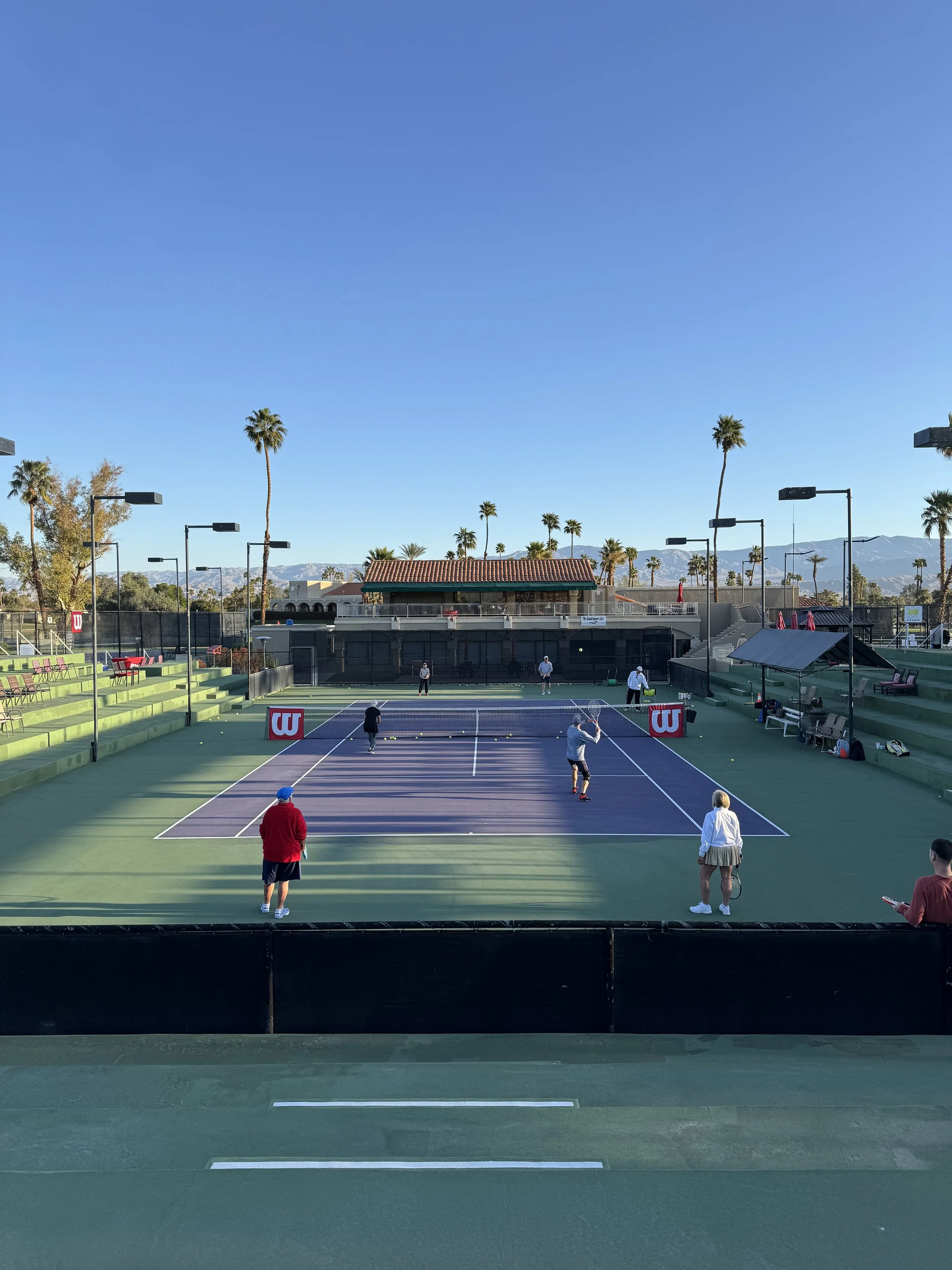 Wide view of early morning tennis liveball. 