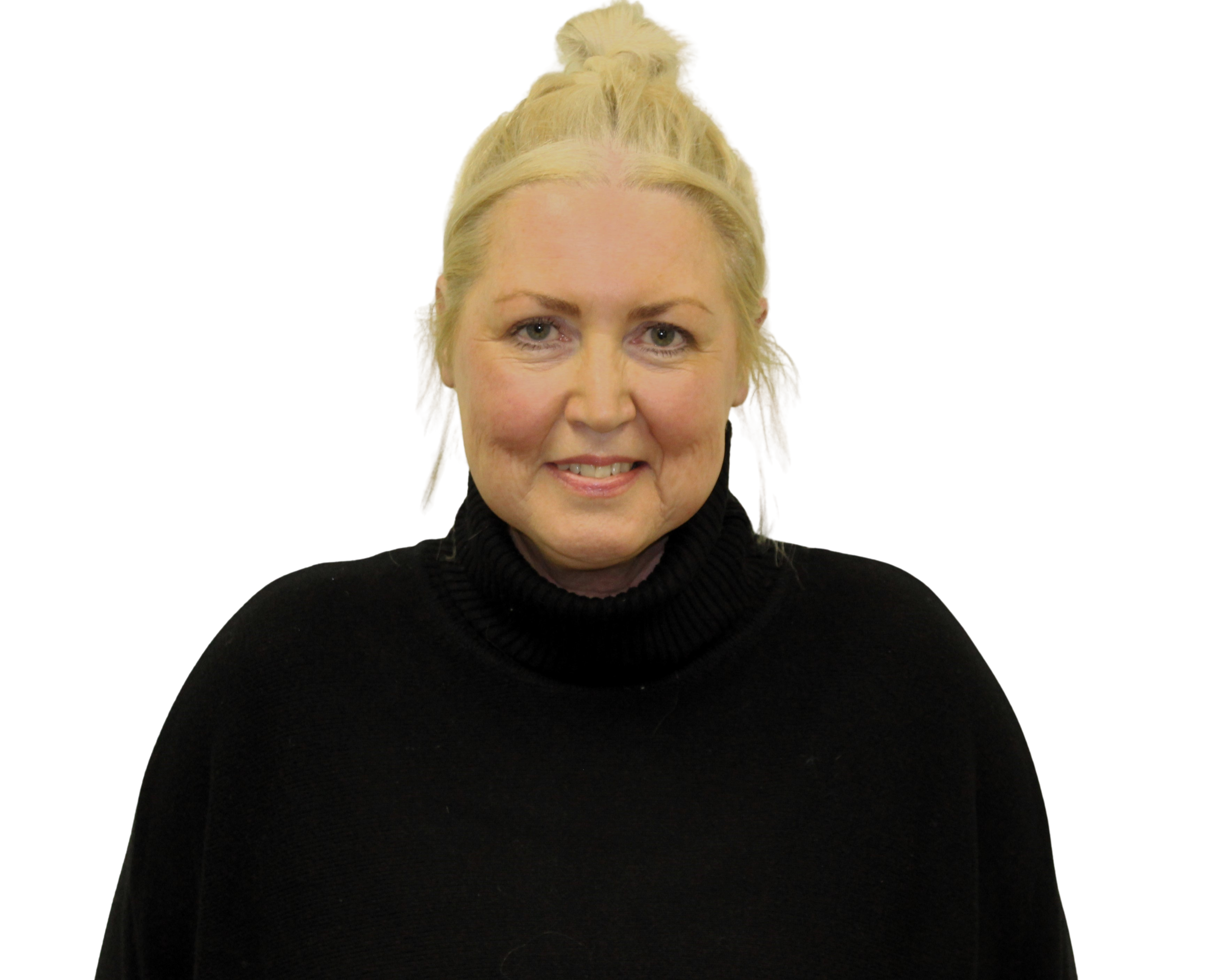 Smiling elderly woman with white hair, wearing glasses and a patterned blouse, accessorized with earrings and a beaded necklace.