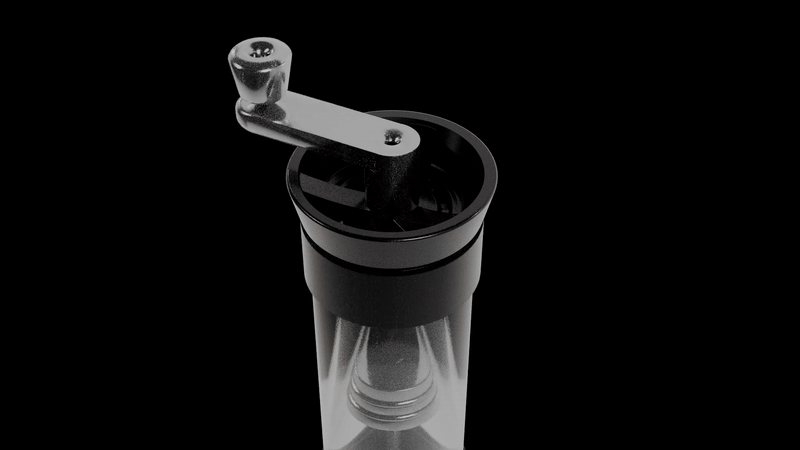 Black spice grinder with a clear container and a silver handle on top, against a black background.