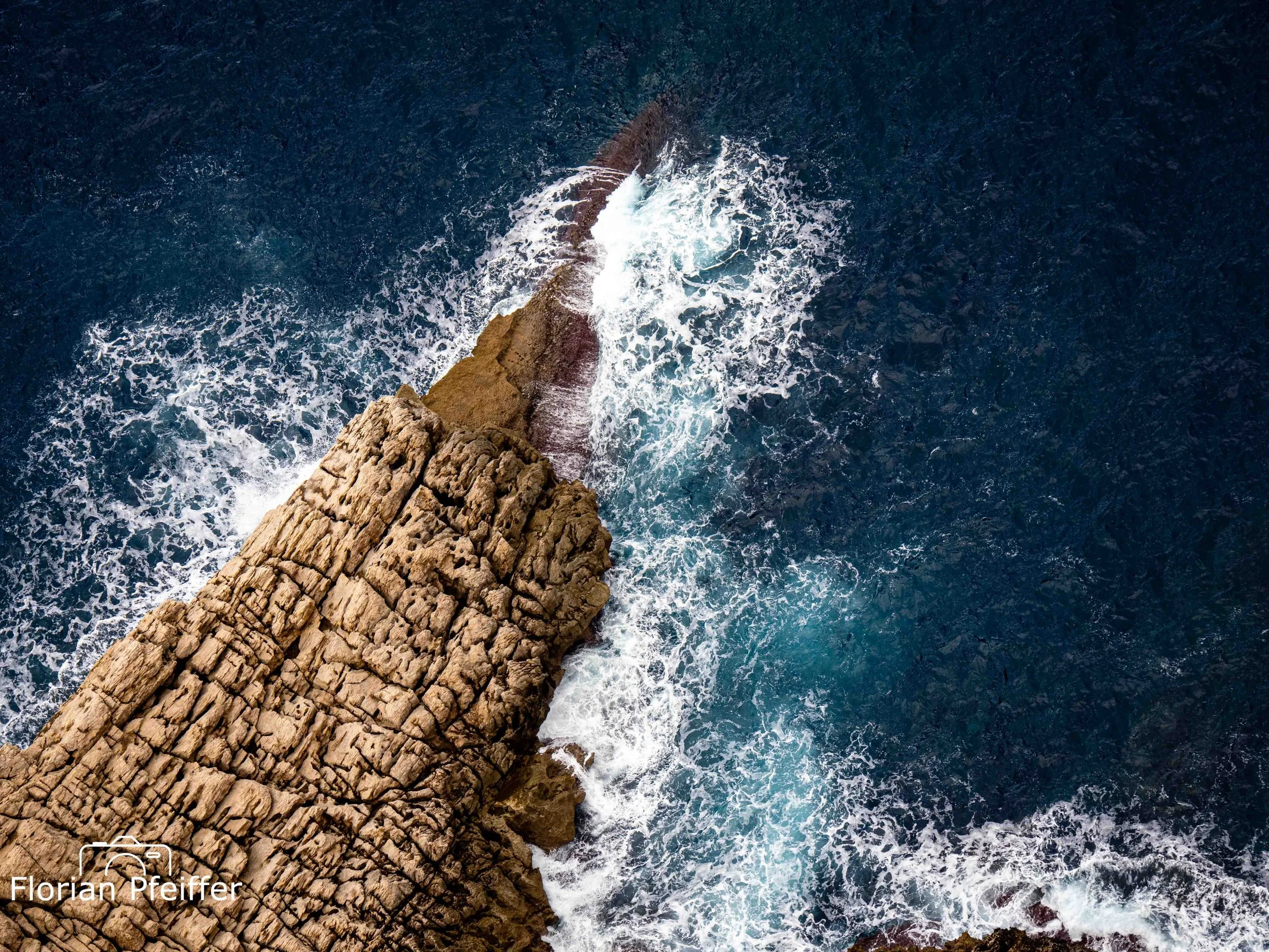 coast view from above with waves and rocks
