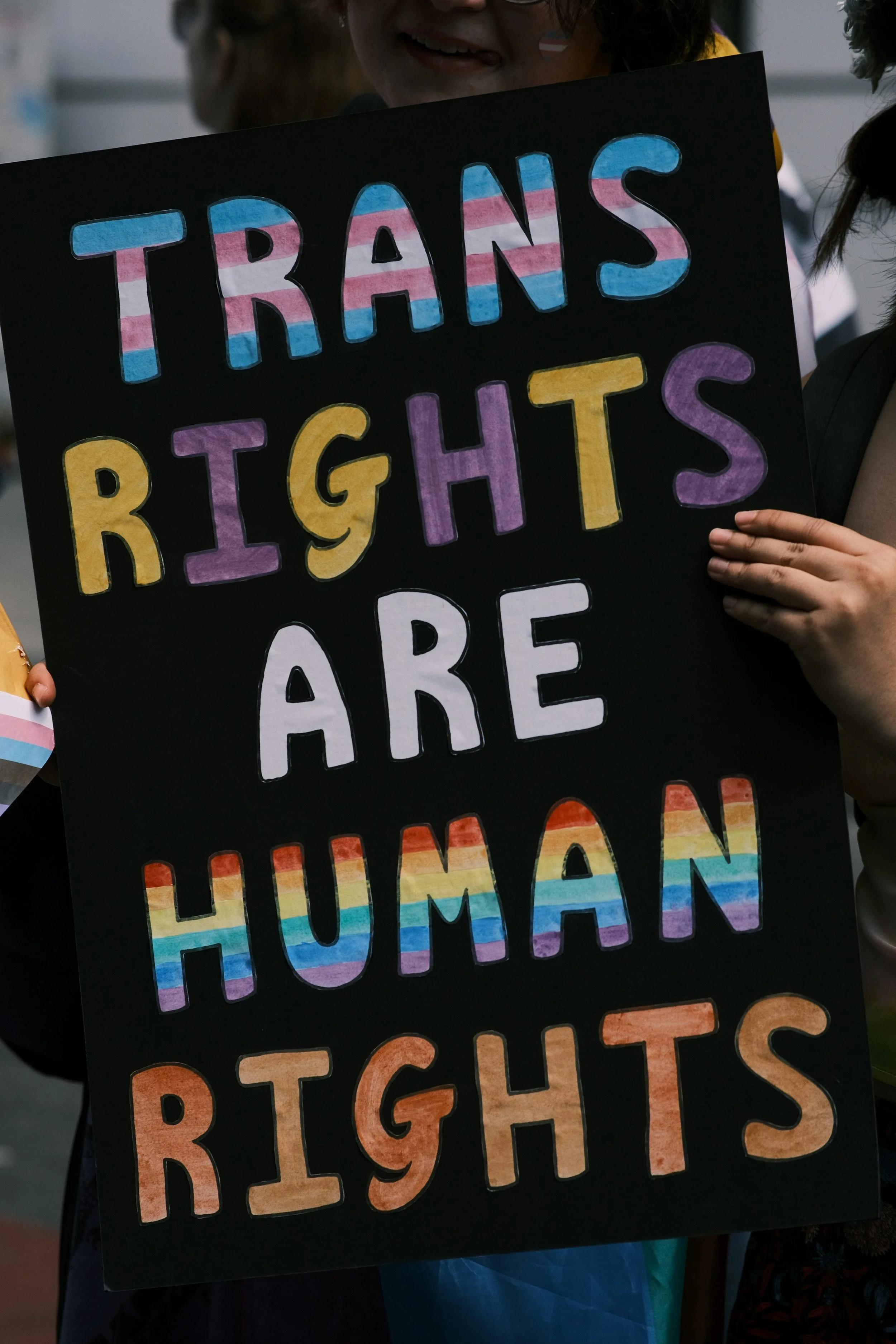 Trans rights sign online gender affirming therapy Massachusetts