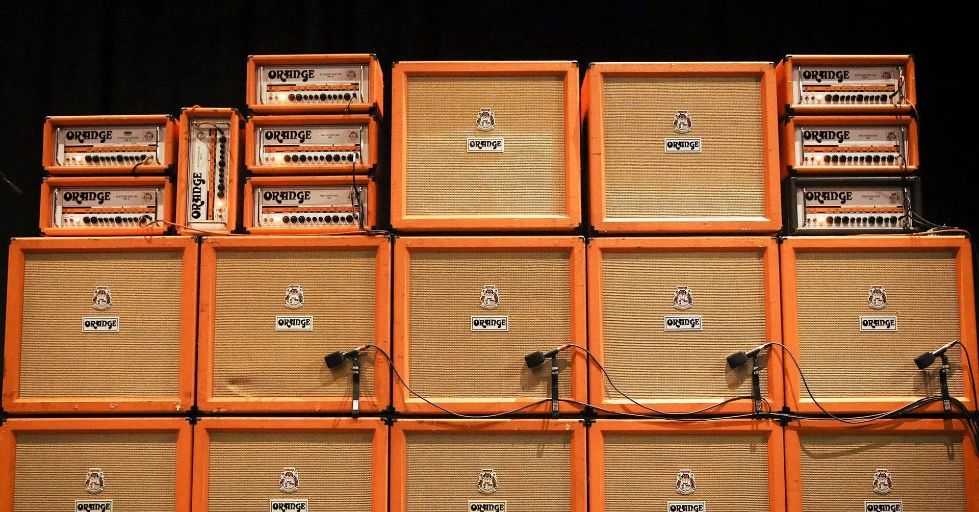 A wall of Orange guitar amplifiers, available to try at Fuzzy’s Fine Guitars in Warwick, Rhode Island.