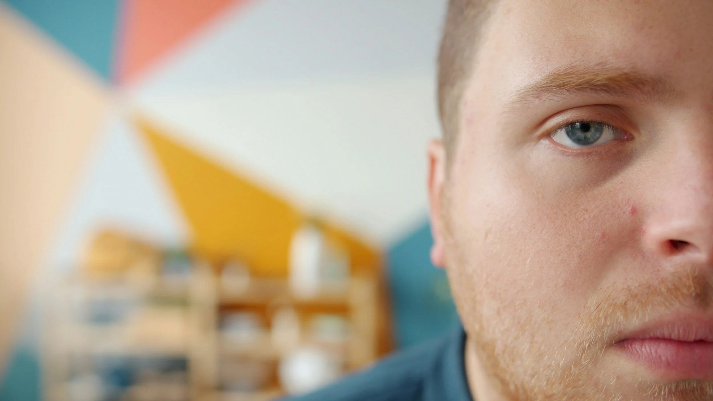 anterior view of half a mans face featuring his one blue eye