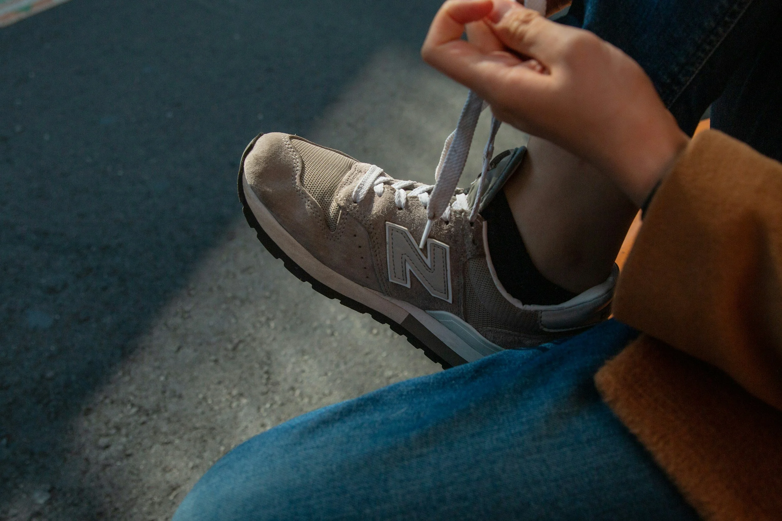 an individual tying their shoe