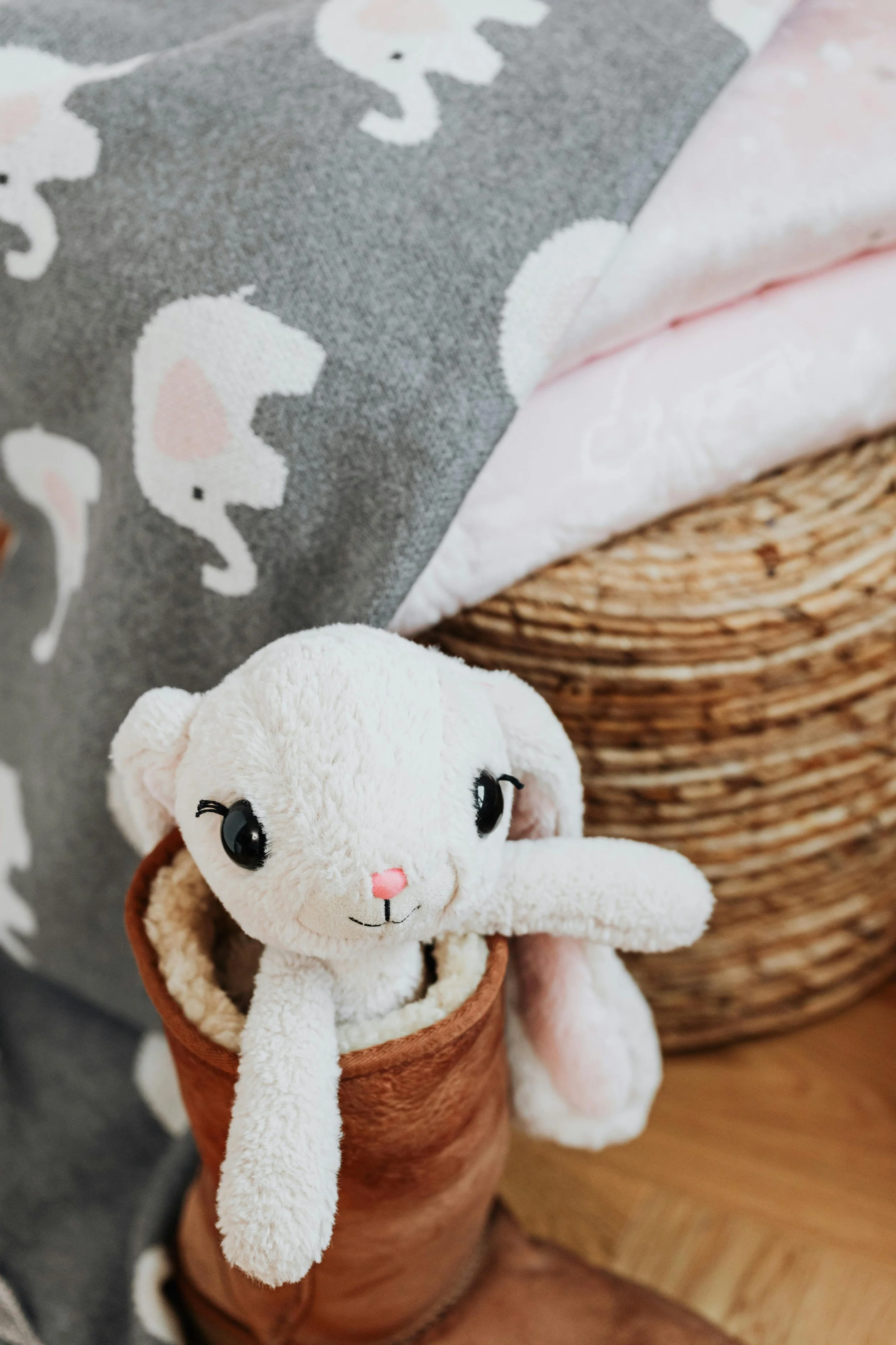 Child’s stuffed animal resting on soft blankets and pillows used for calming sensory play at home.