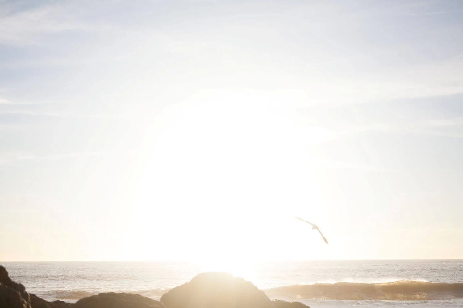Sunrise over ocean waves with rocky shore, symbolizing hope and new beginnings at Sunrise Therapies, mobile OT and autism education.