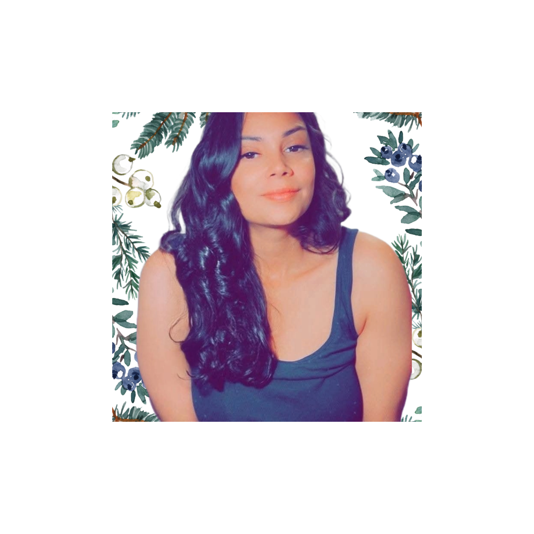 Woman with long black hair, wearing a black tank top, surrounded by botanical illustrations of evergreen and berries.