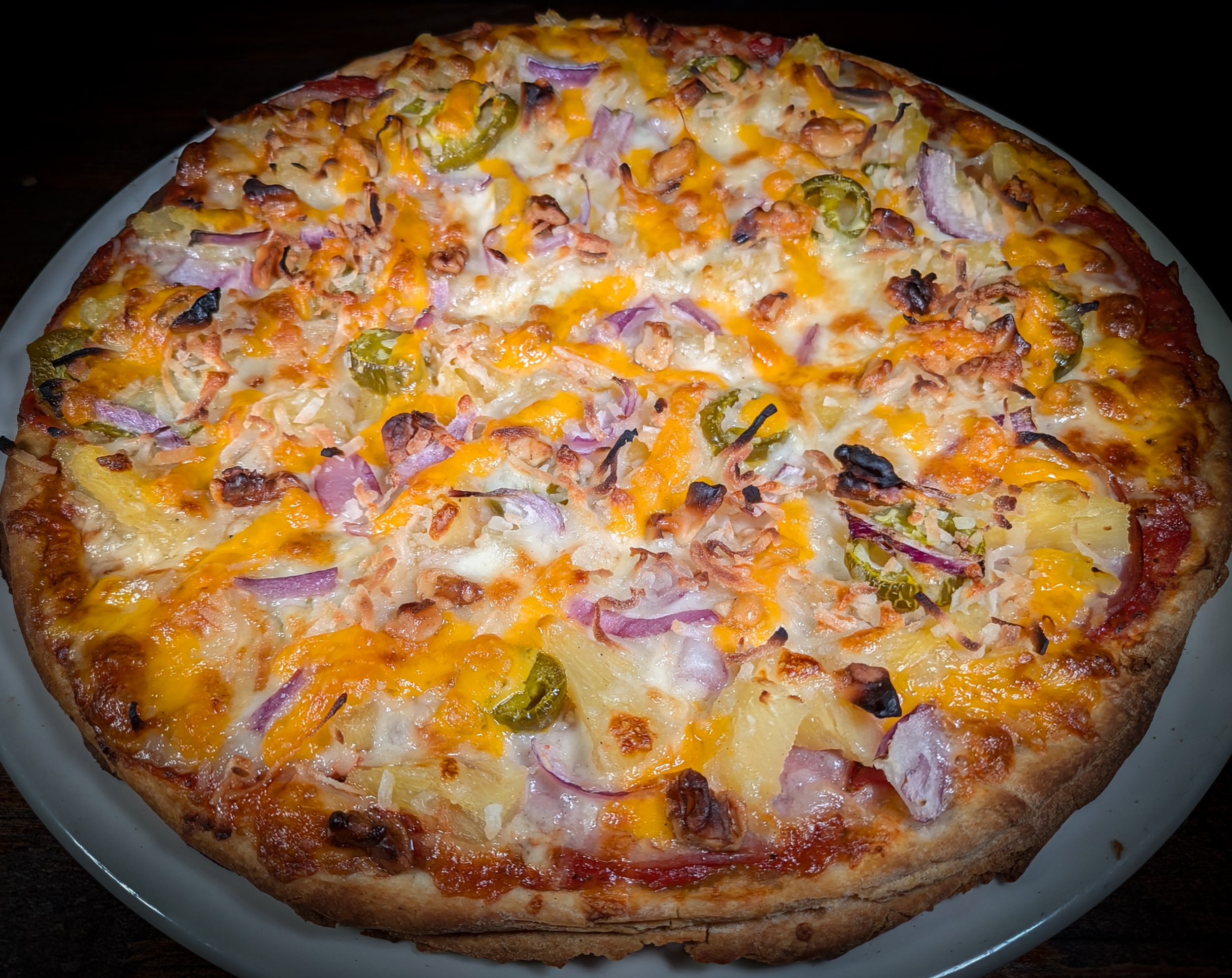  Twin Thin Luao pizza from Bryn Mawr Pizza & Deli topped with Canadian bacon, pineapple, jalapeños, red onion, cheddar, walnuts, and coconut flakes