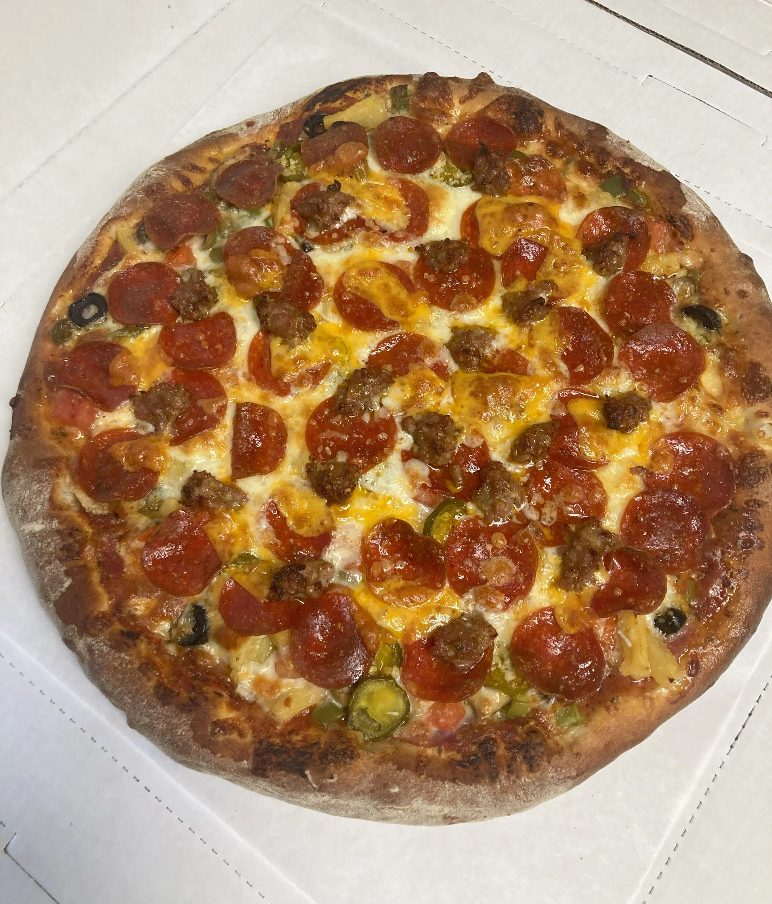 Meatasaurus pizza from Bryn Mawr Pizza & Deli loaded with Canadian bacon, pepperoni, sausage, and bacon