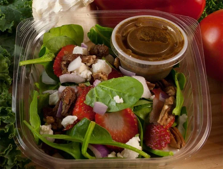 Spinach salad from Bryn Mawr Pizza & Deli with strawberries, red onion, fresh mozzarella, candied pecans, and orange ginger basil vinaigrette