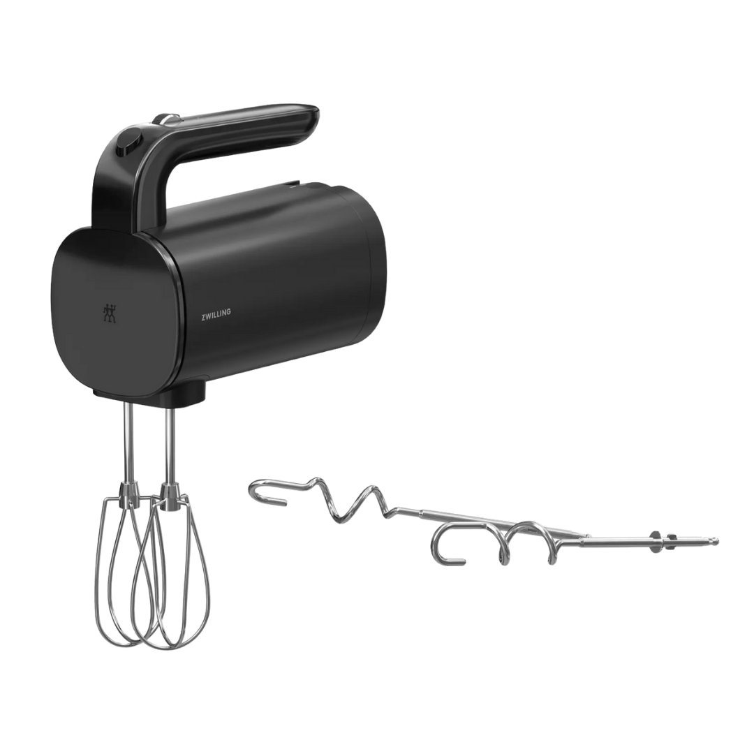 Black hand mixer with beaters attached and a metal whisk attachment.