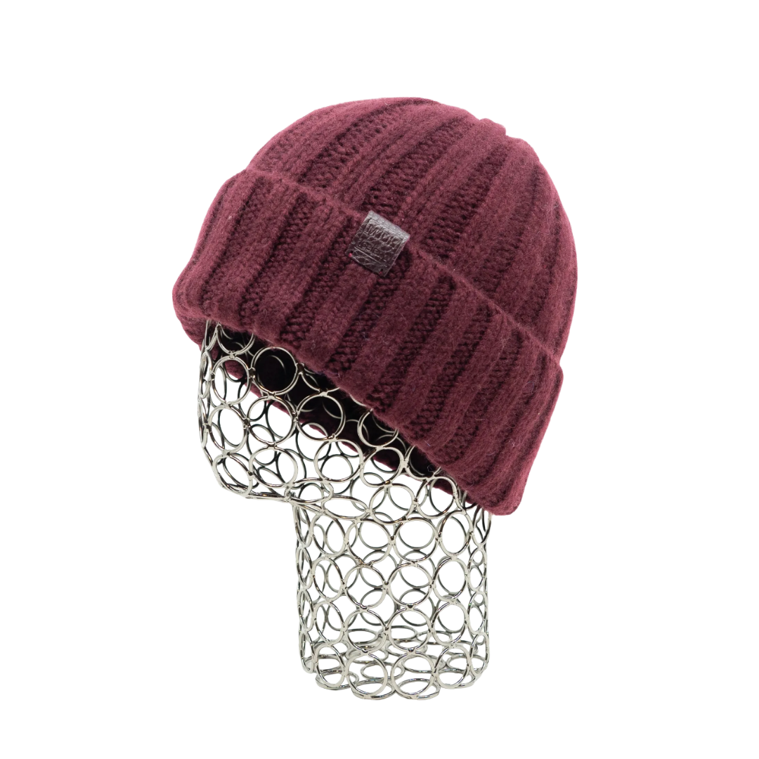 Maroon knit beanie hat displayed on a metallic wire mannequin head.