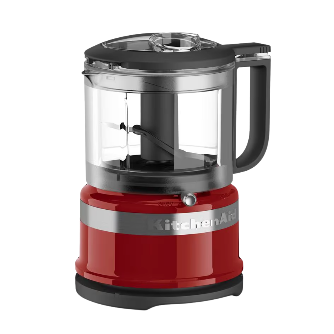 Red KitchenAid food chopper with a clear plastic bowl and black lid.