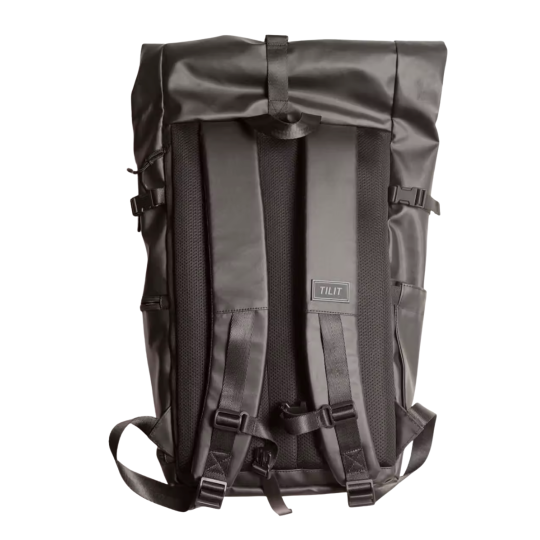 Black TILT backpack with padded shoulder straps and adjustable straps on a white background