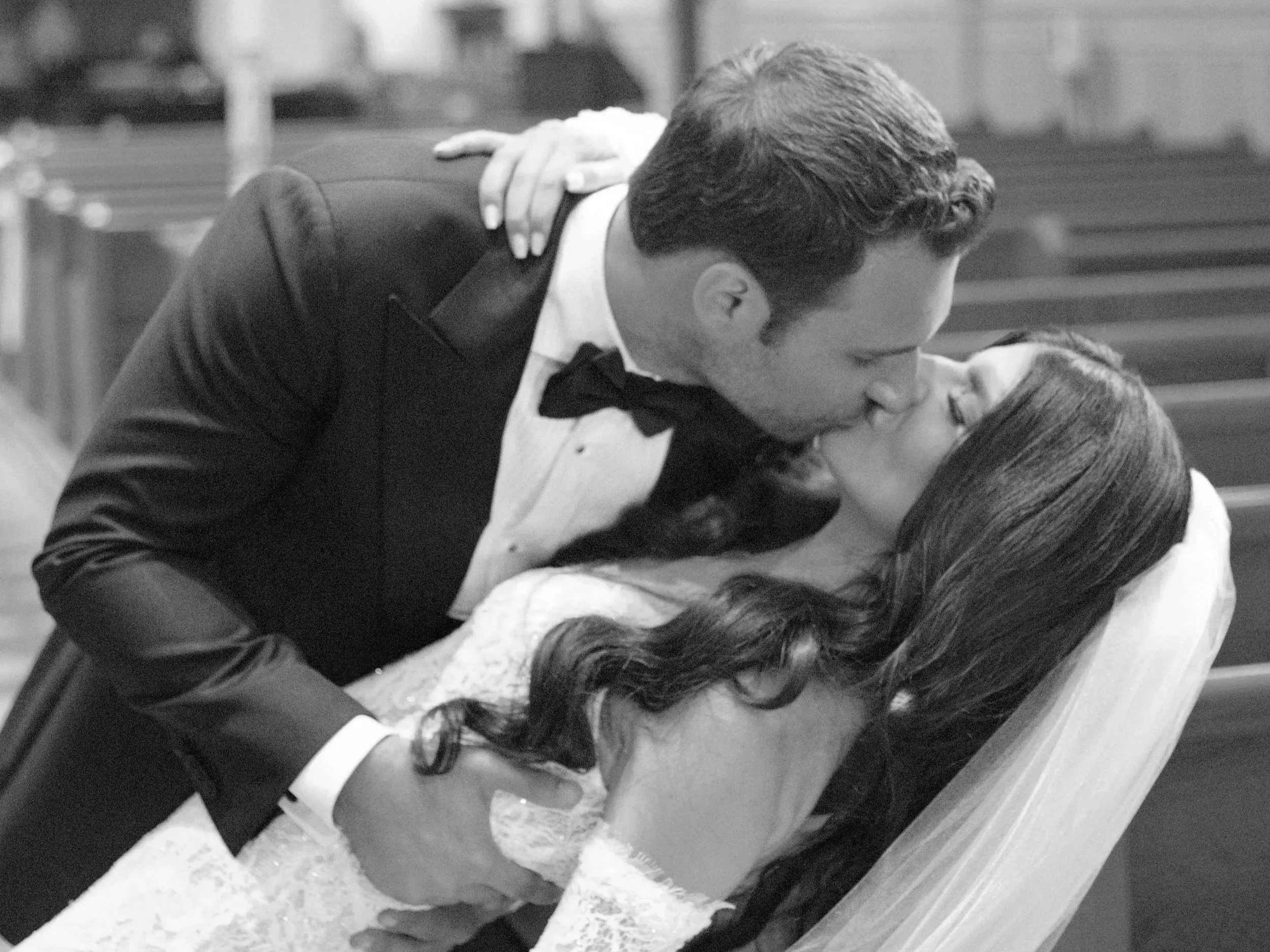 Interior of St. Patrick Roman Catholic Church in Chatham, NJ featuring stained glass windows, marble floors, and grand two-story arches during a Catholic wedding ceremony. NJ Wedding Content Creator