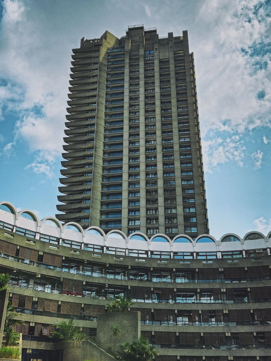 A low-rise pavilion block at the Barbican Estate, London, showing stacked concrete balconies and walkways