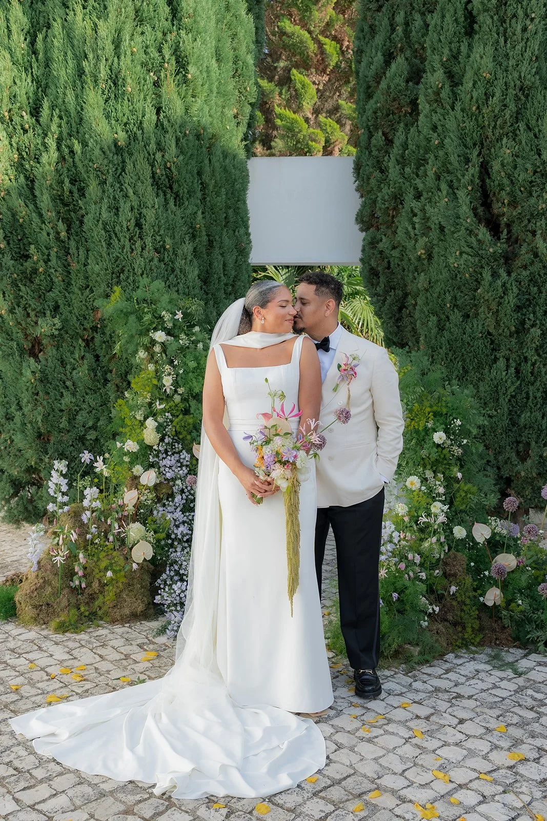 Bride and groom with their ceremony decor behind
