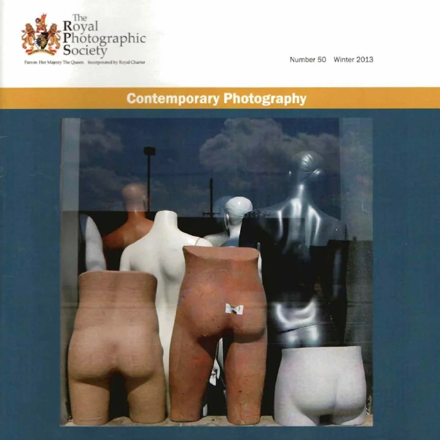 Cover of a magazine titled 'Contemporary Photography' by the Royal Photographic Society, Winter 2013 issue, featuring a display of mannequin torsos and backs varying in skin tones and textures, with a reflection of the sky and clouds in the background.