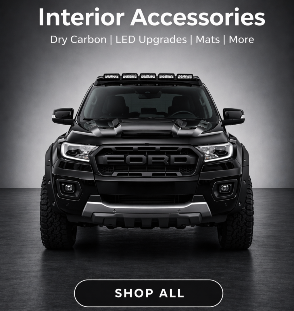 Black Ford pickup truck with LED light bar on roof and large off-road tires, set against a gray background, with text promoting interior accessories including dry carbon, LED upgrades, mats, and more, and a button labeled "Shop All".