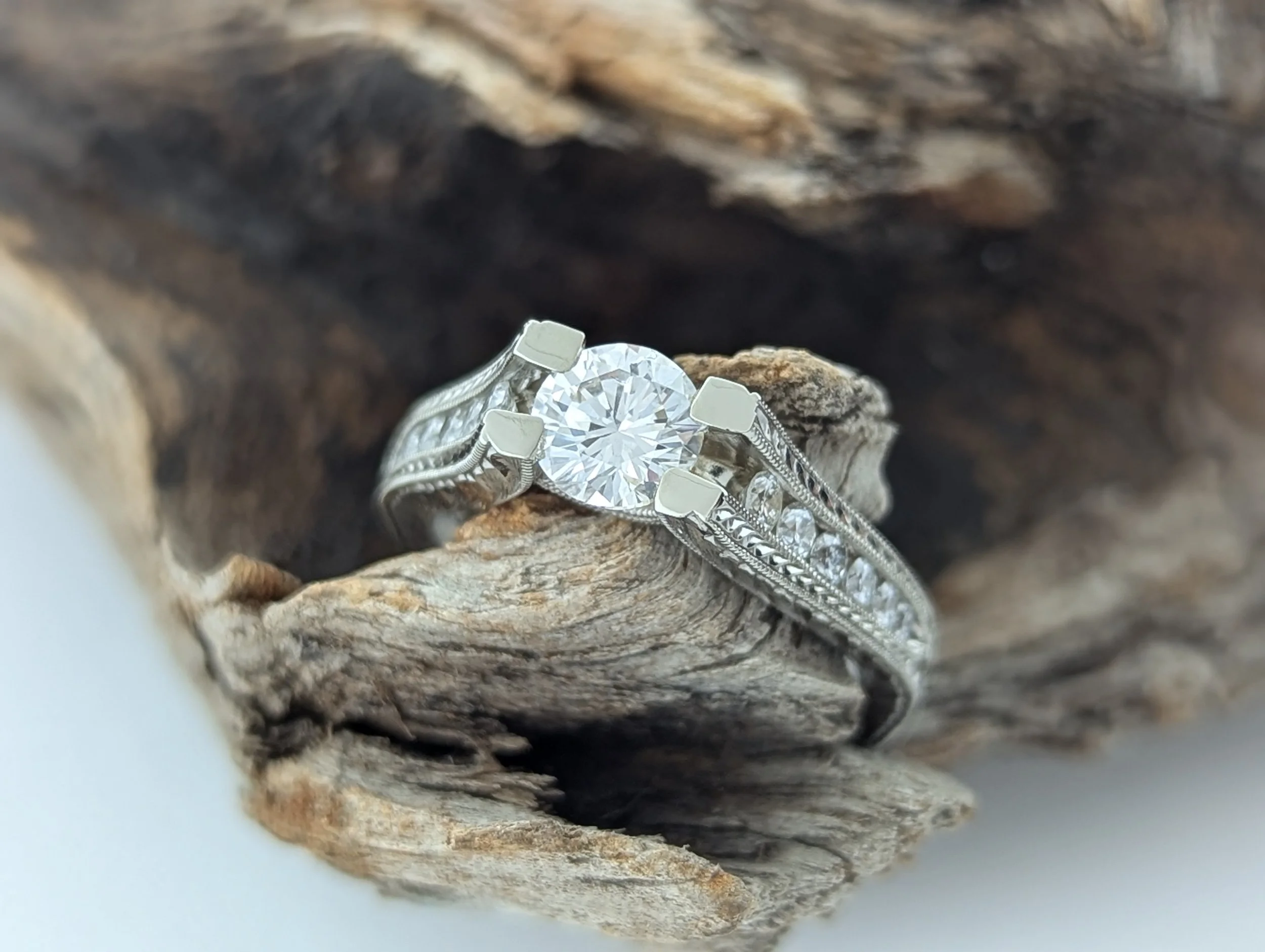 0.71ct round brilliant cut diamond ring with engraved 14k white gold band, diamond accents, and a European shank design.