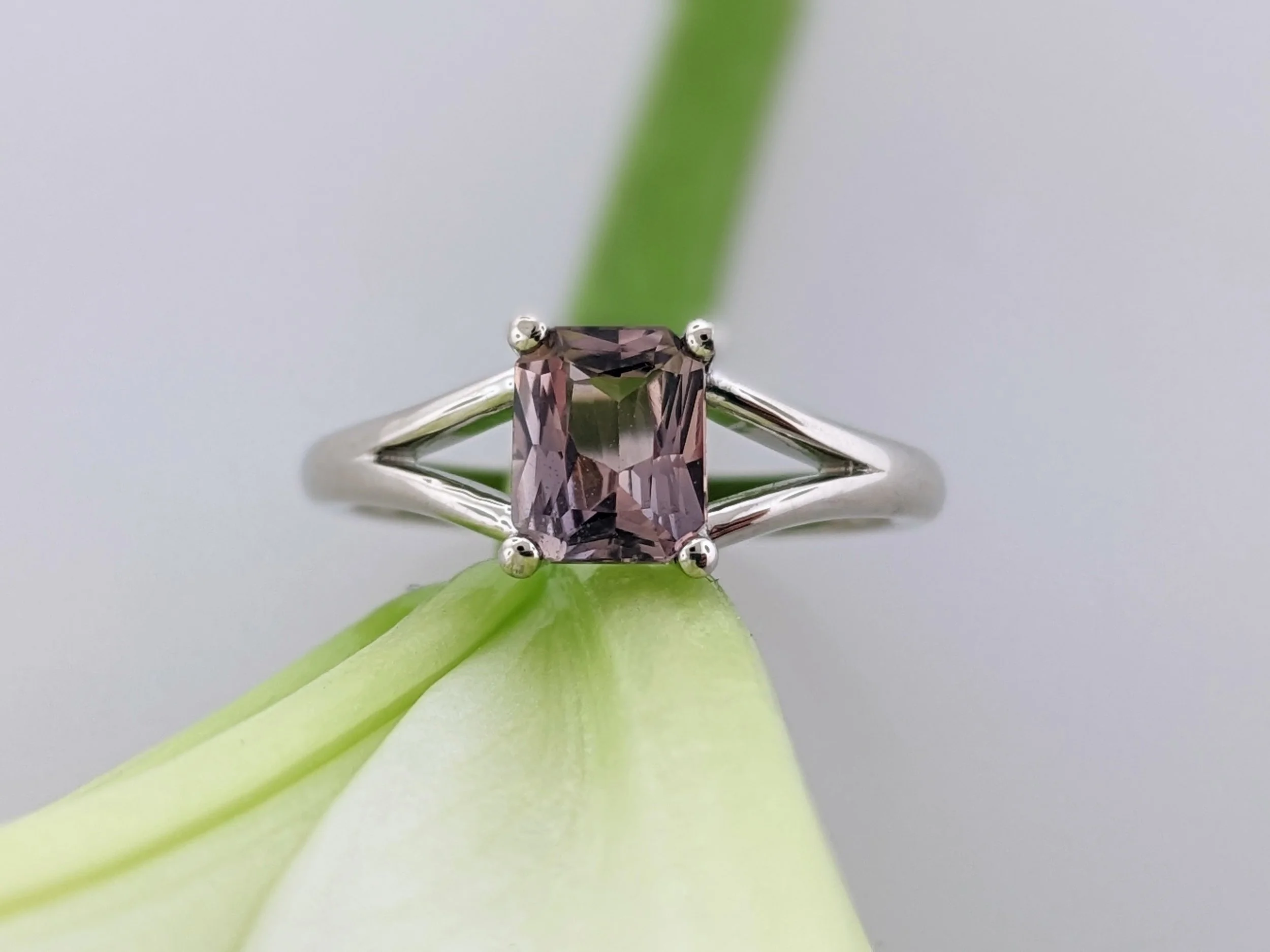 1.17ct radiant cut Montana Sapphire ring in 14k white gold with a light amber pink gemstone and split band design.