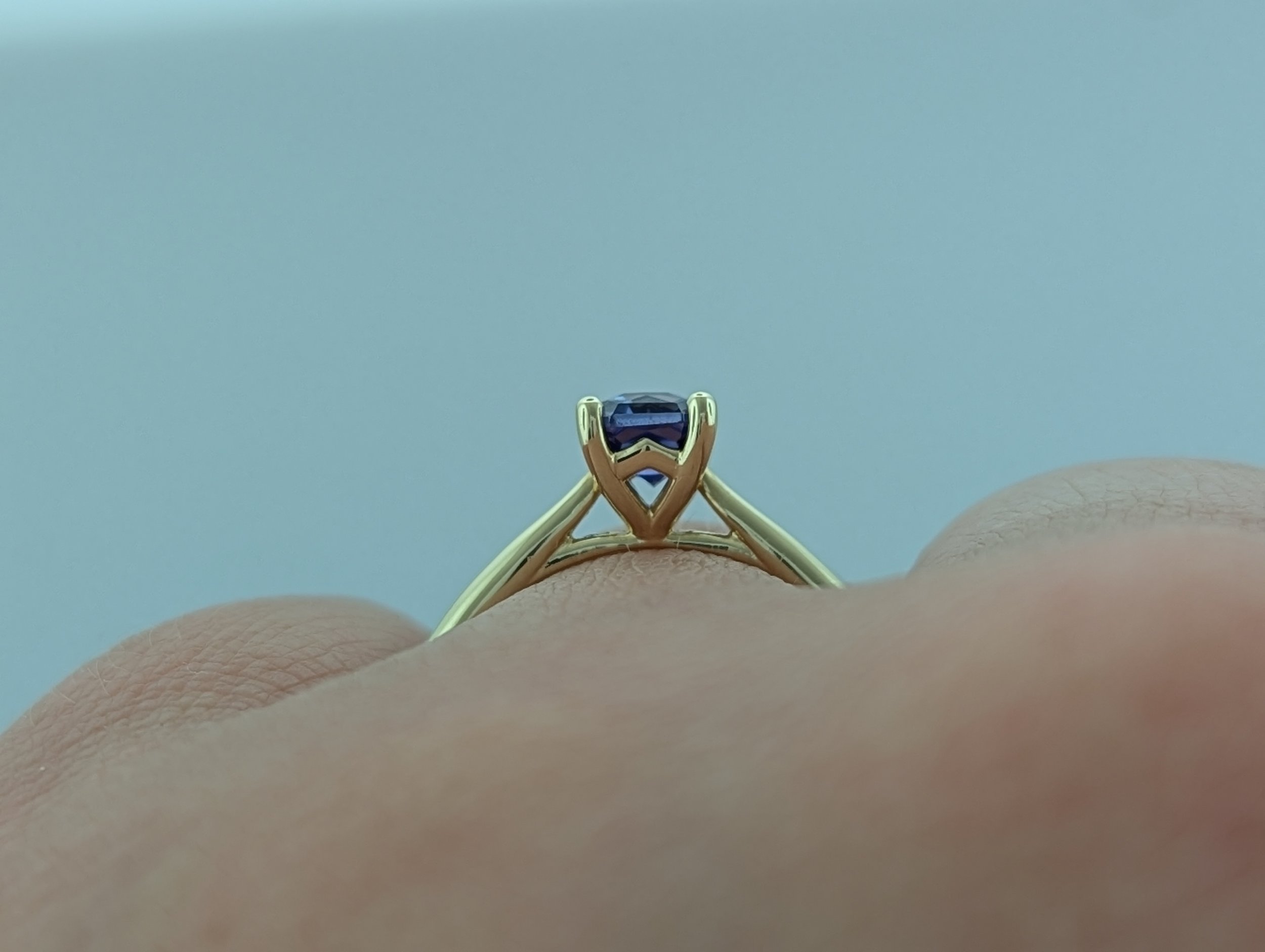 0.97ct radiant cut purple Montana Yogo Sapphire solitaire ring in 14k yellow gold.