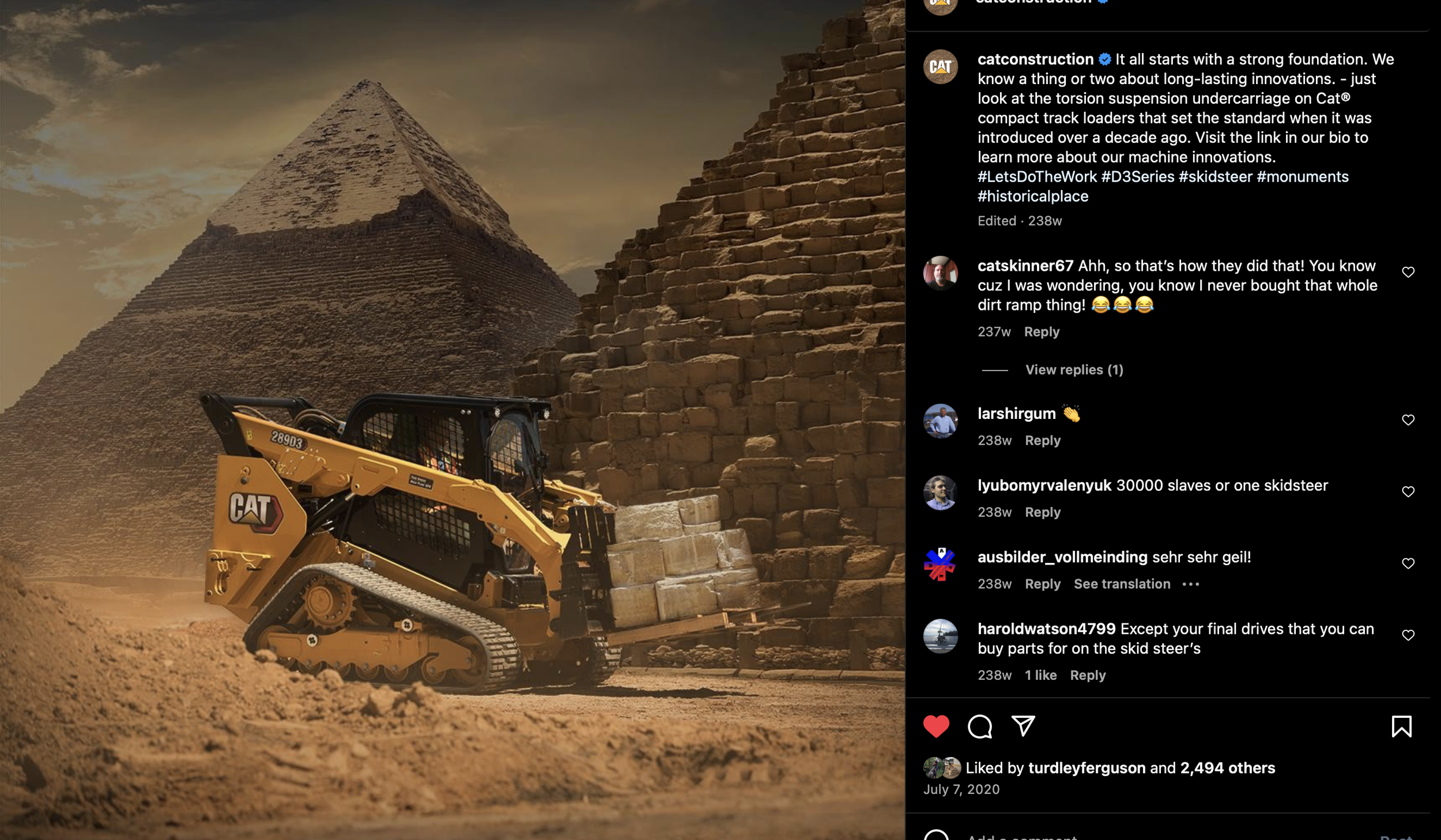 A modern construction loader, branded with CAT, is positioned in front of a pyramid in an Egyptian desert setting. The loader is carrying large limestone blocks, with another pyramid in the background. The scene combines ancient and modern constructi
