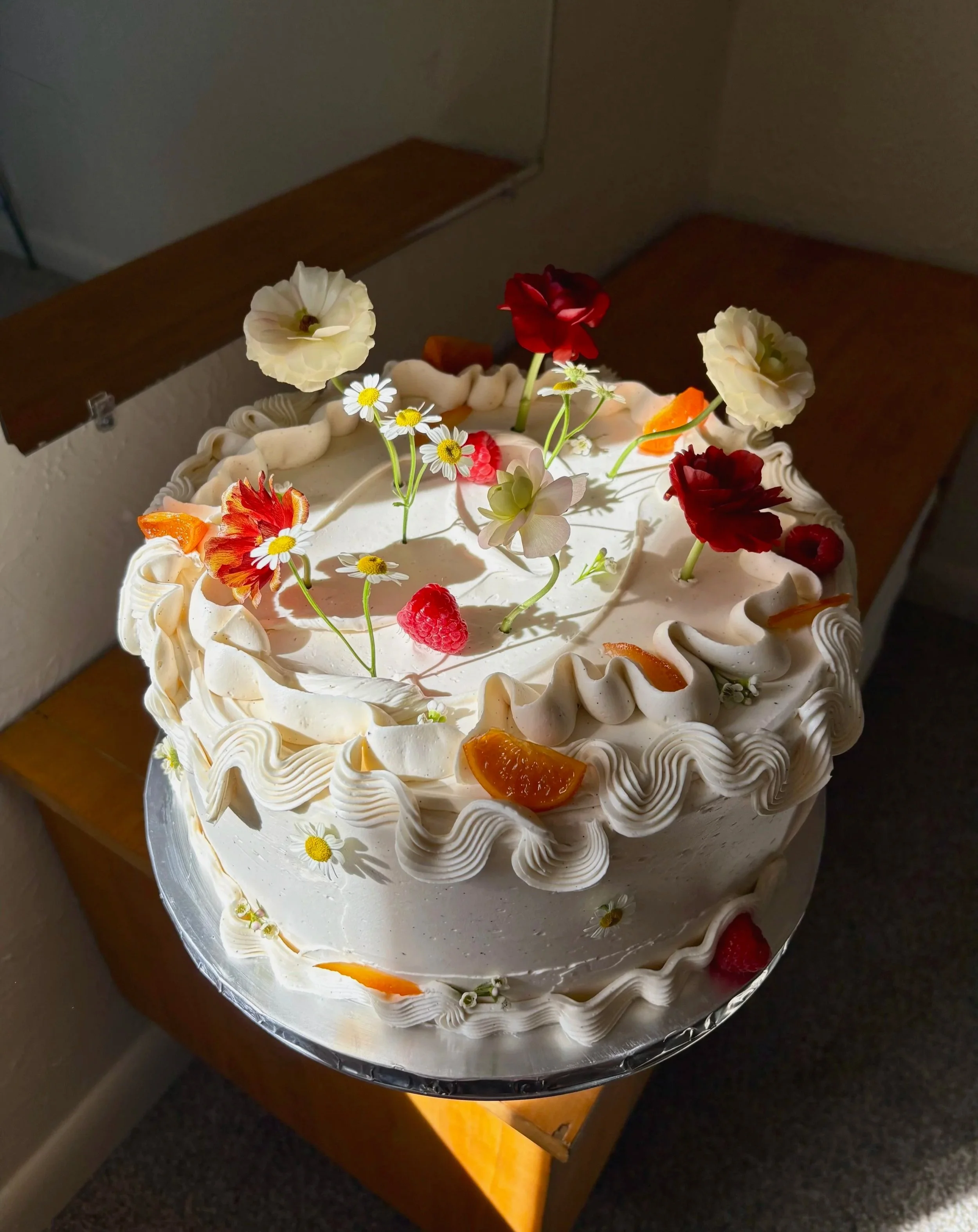 yecora rojo lime chiffon / strawberry jam / passionfruit mousse / vanilla creme fraiche swiss meringue buttercream / candied clementine wedges + orange peel