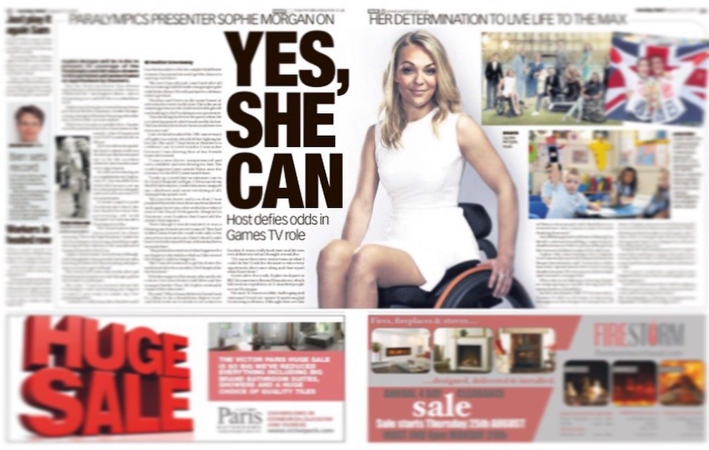 A newspaper page featuring a large headline with the words "YES, SHE CAN" and a woman sitting in a wheelchair, smiling, with other smaller images and advertisements on the page.