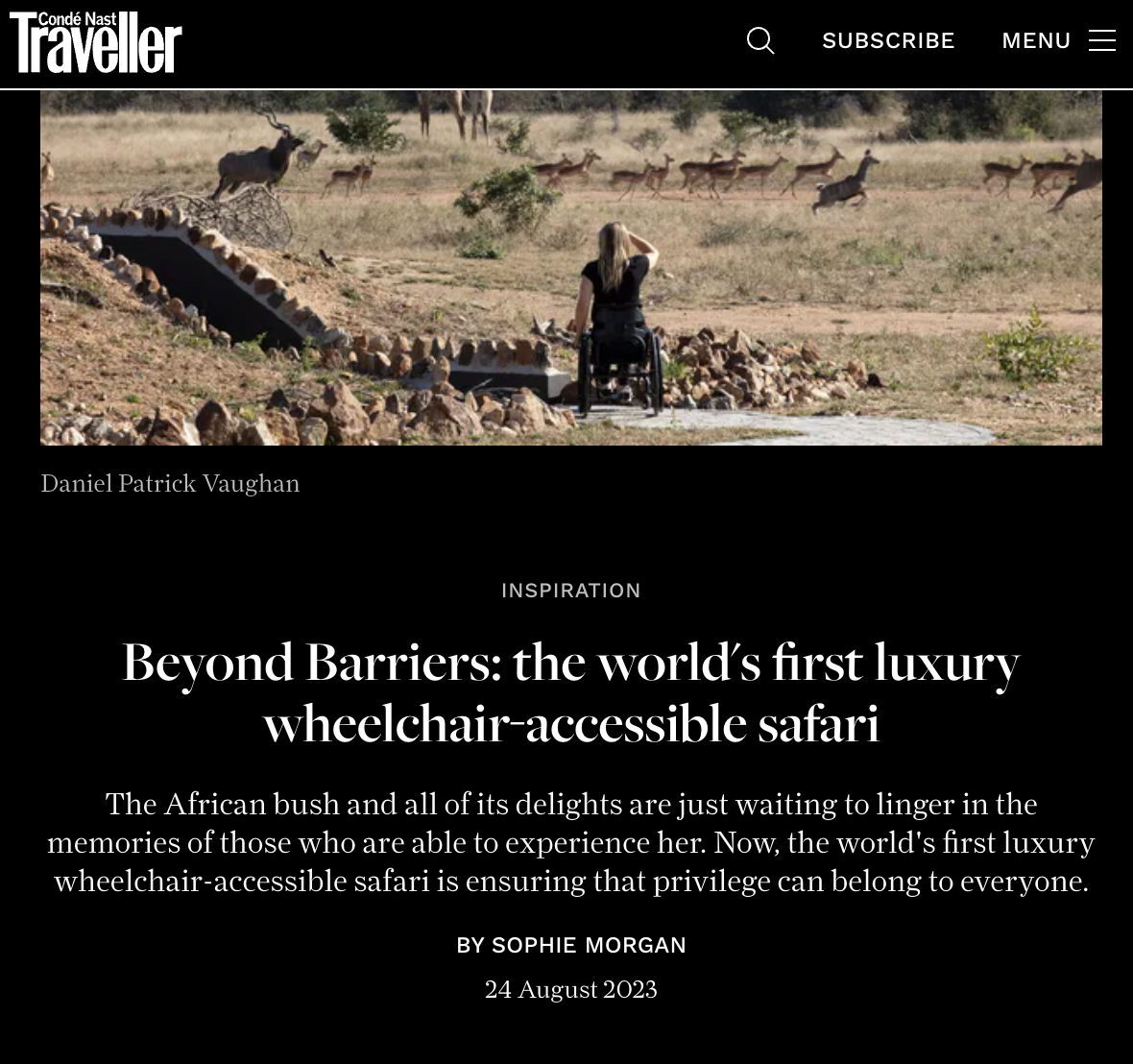 A person in a wheelchair observing wildlife in an African safari setting with antelopes in the background.