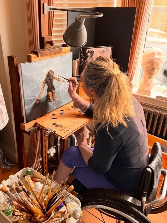 Artist painting a realistic portrait of a woman on canvas in a cozy studio