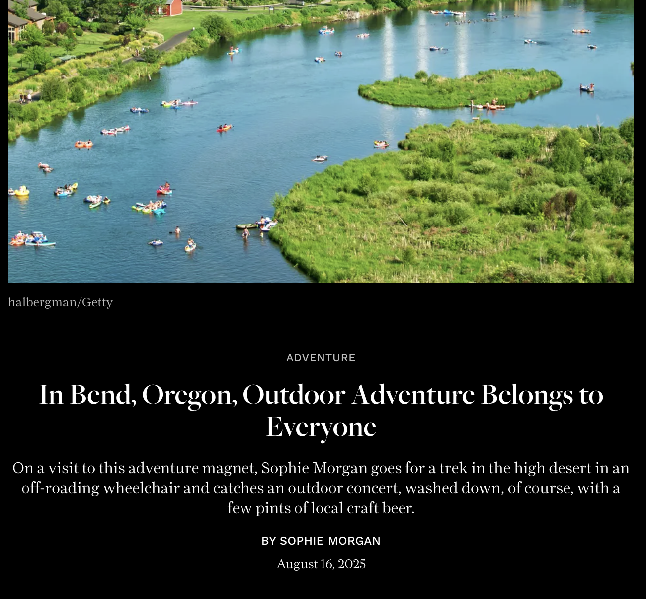 A river scene in Bend, Oregon with multiple small boats, kayaks, and paddleboarders on the water. The river is green with lush vegetation on the banks, and there's a grassy island in the middle.
