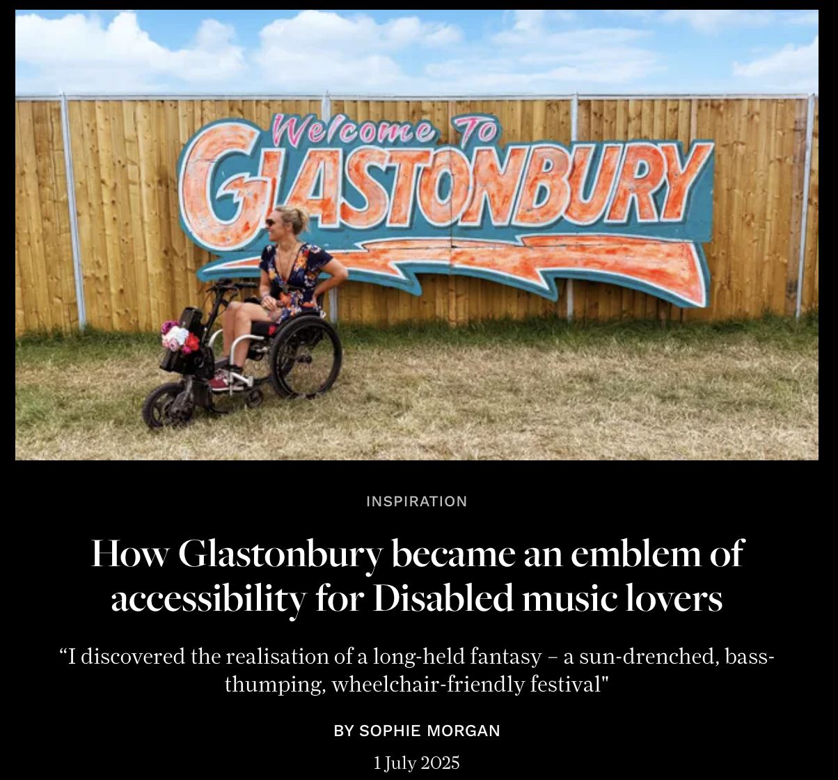Woman in a wheelchair with a flower bouquet sitting in front of a "Welcome to Glastonbury" sign on a wooden fence.