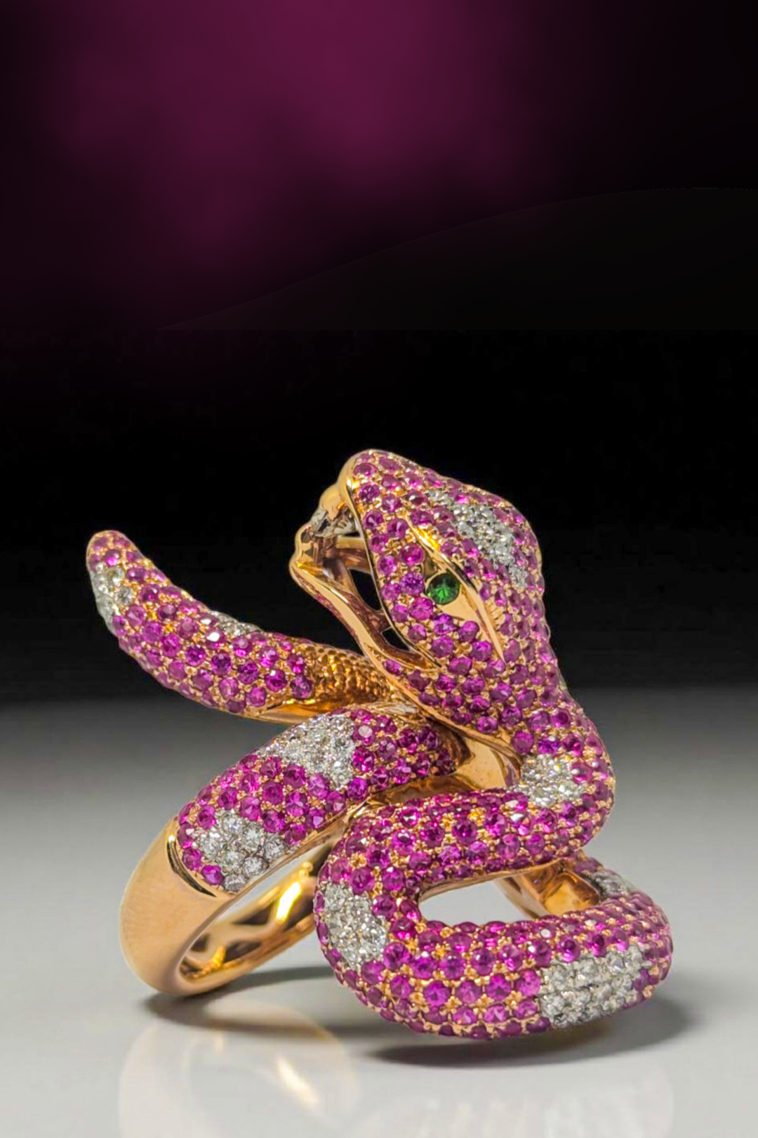Snake ring in 18K yellow gold, set with pink sapphires, diamonds, and emeralds 