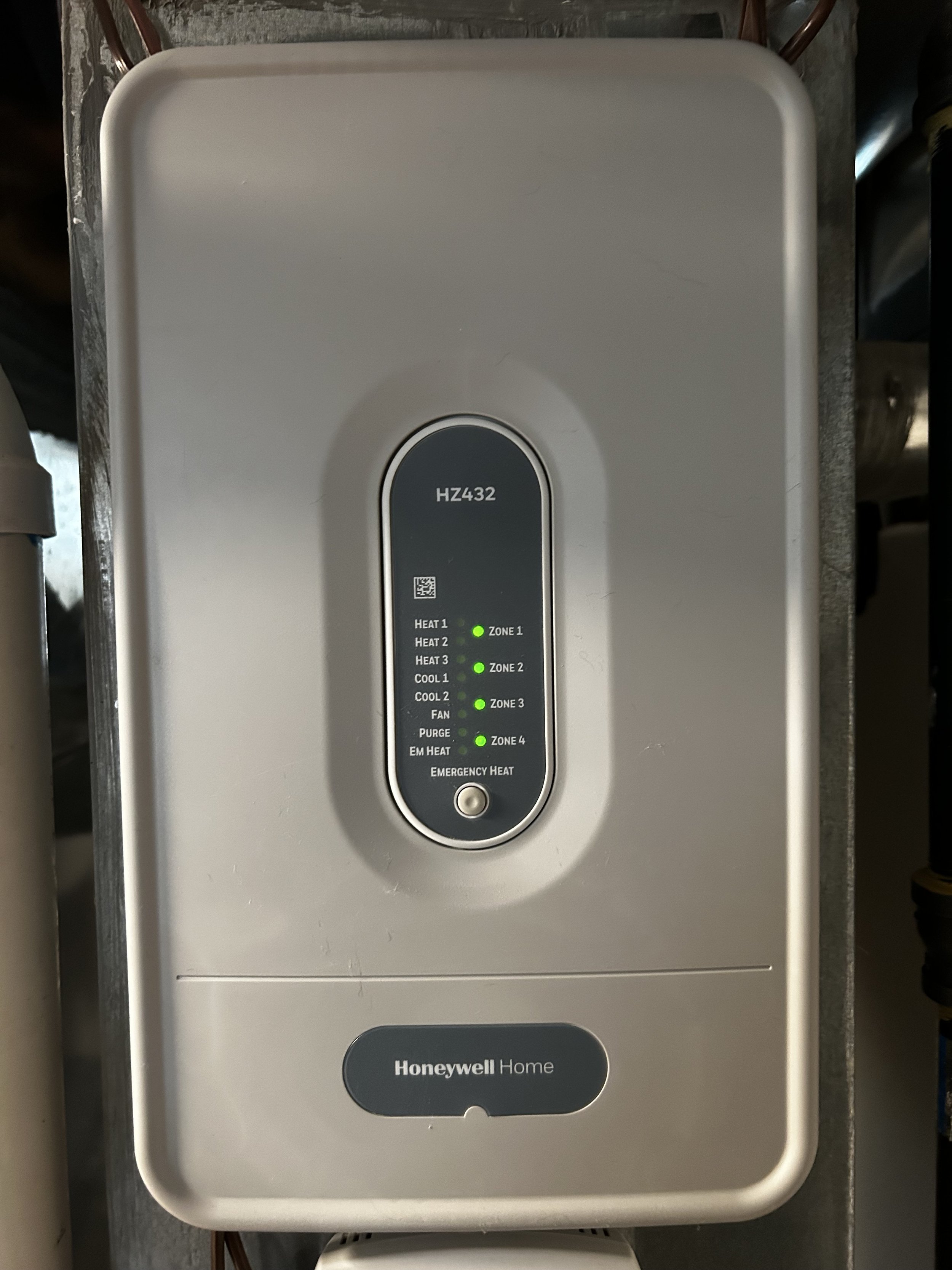 A Honeywell Home zoning control panel with indicator lights for various heating and cooling zones and functions.