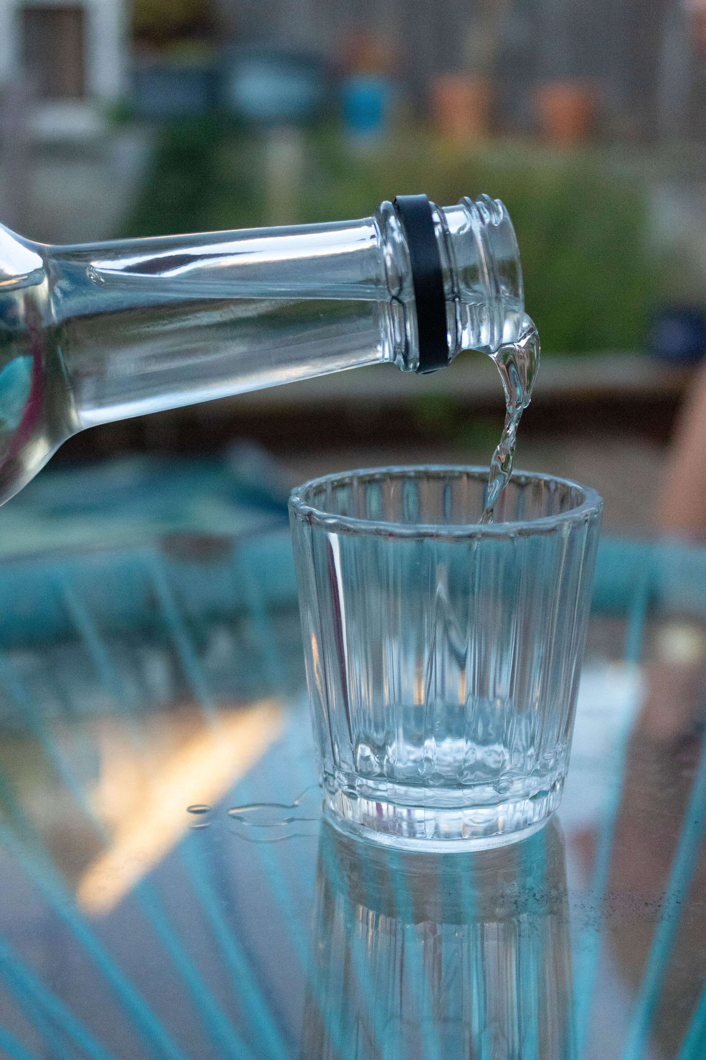 Pouring mezcal to vaso veladora