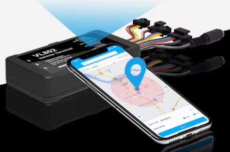 GPS tracking device and smartphone displaying a map with a location pin, connected by wires.