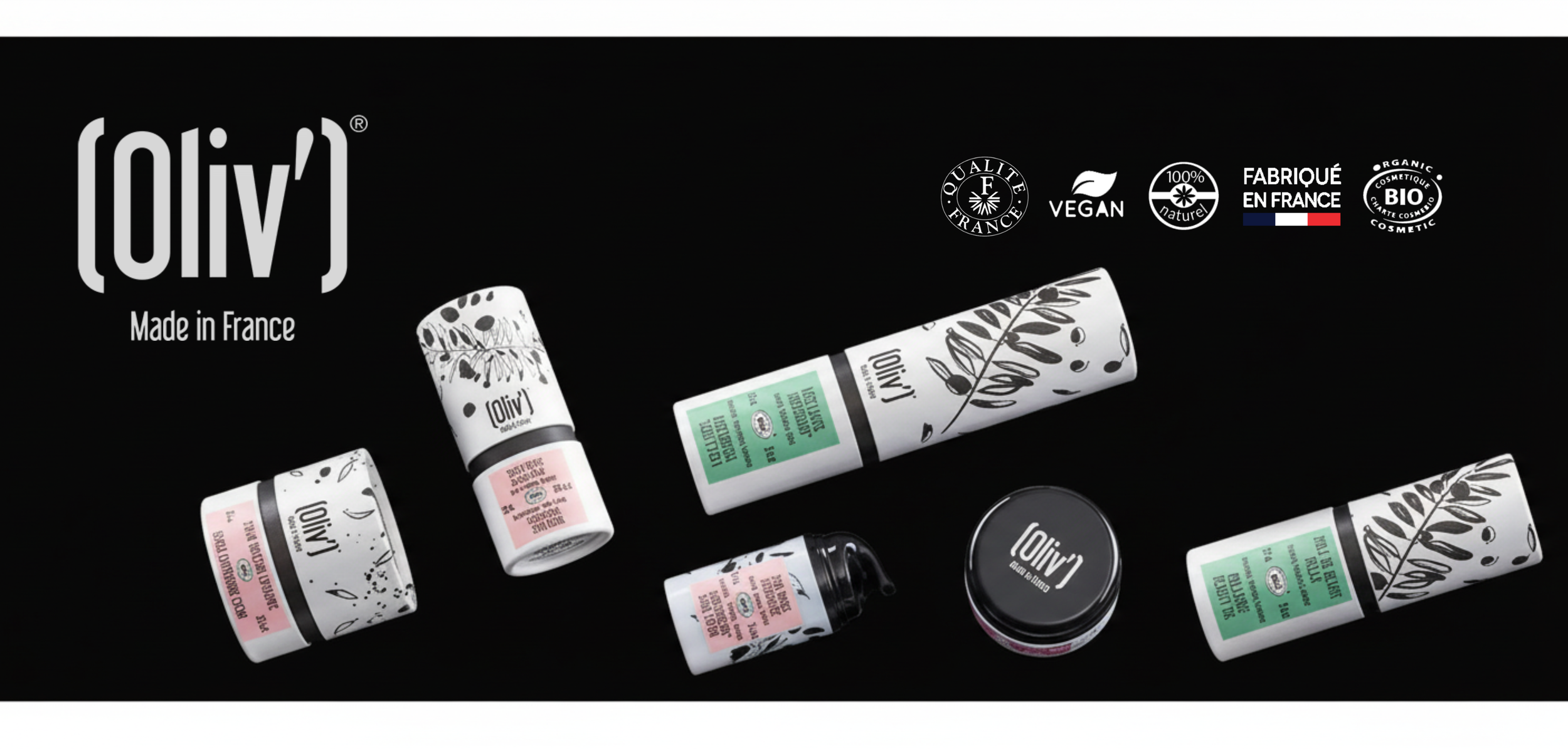 Collection de produits de beauté Oliv' en emballages noirs et blancs avec des détails graphiques, disposés sur un fond noir.