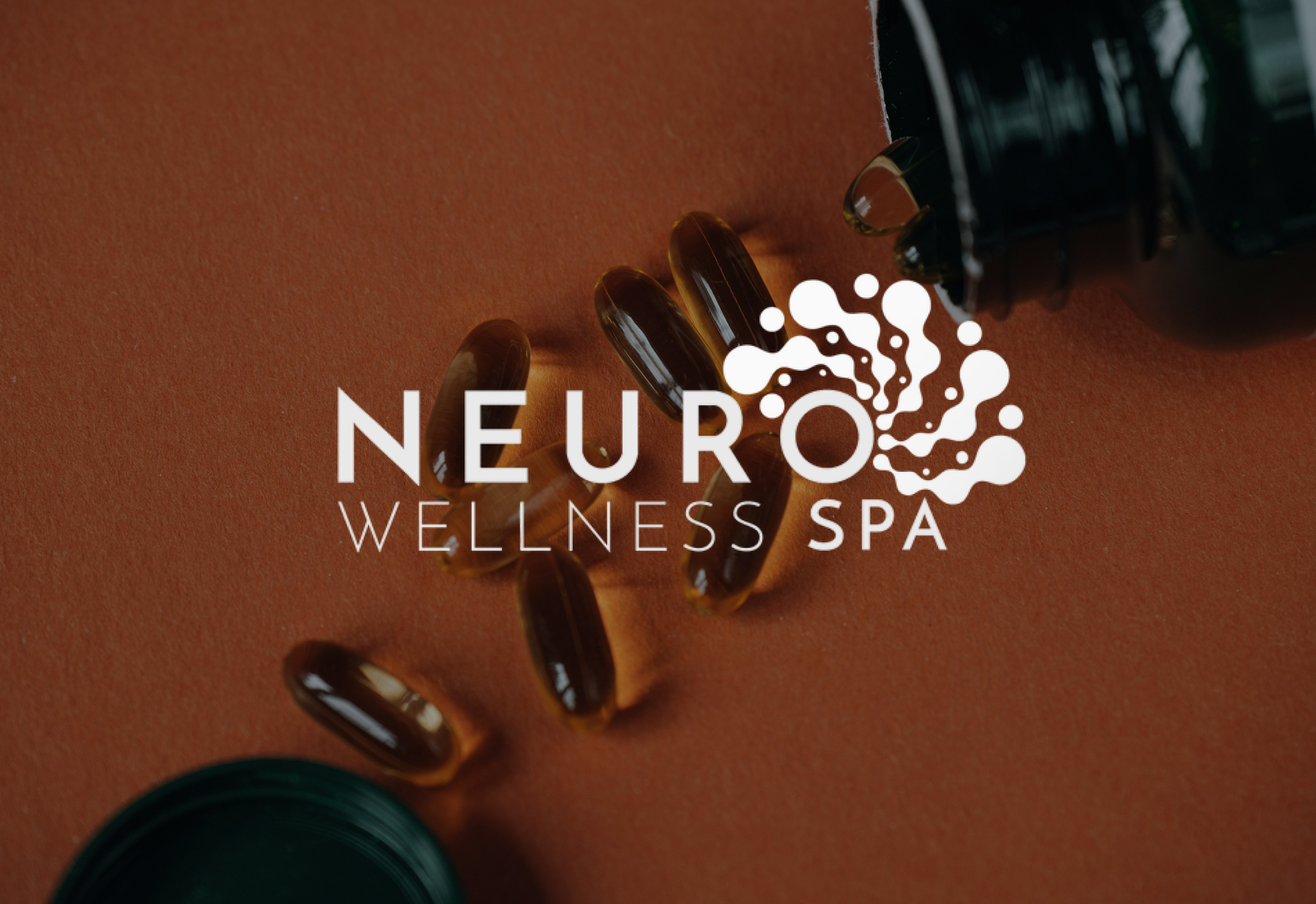 A few dark capsule pills scattered on a brown surface with spa branding overlayed.