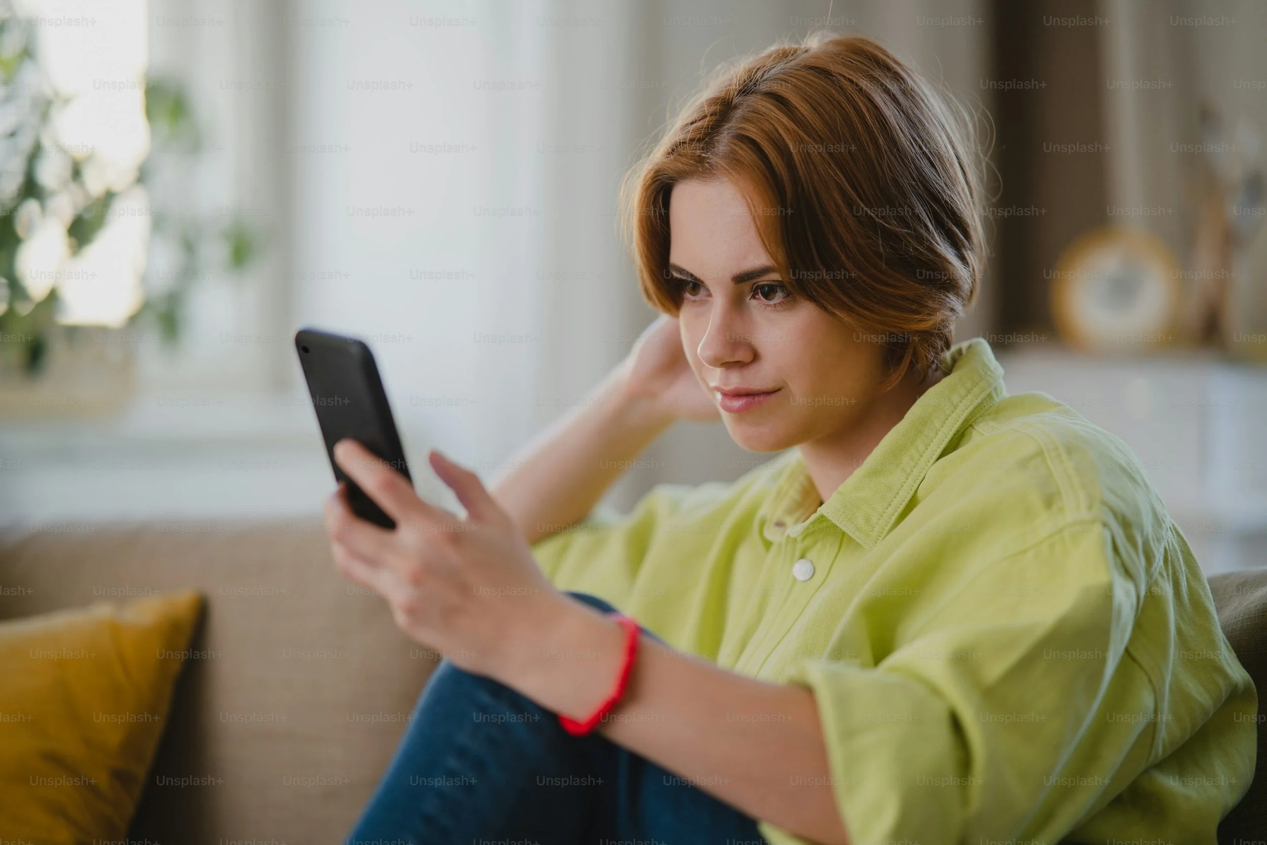 Woman checking her phone, staying connected with an eSIM while test-driving life abroad