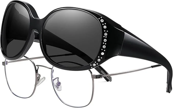 A pair of black sunglasses layered over a pair of silver rimmed eyeglasses.
