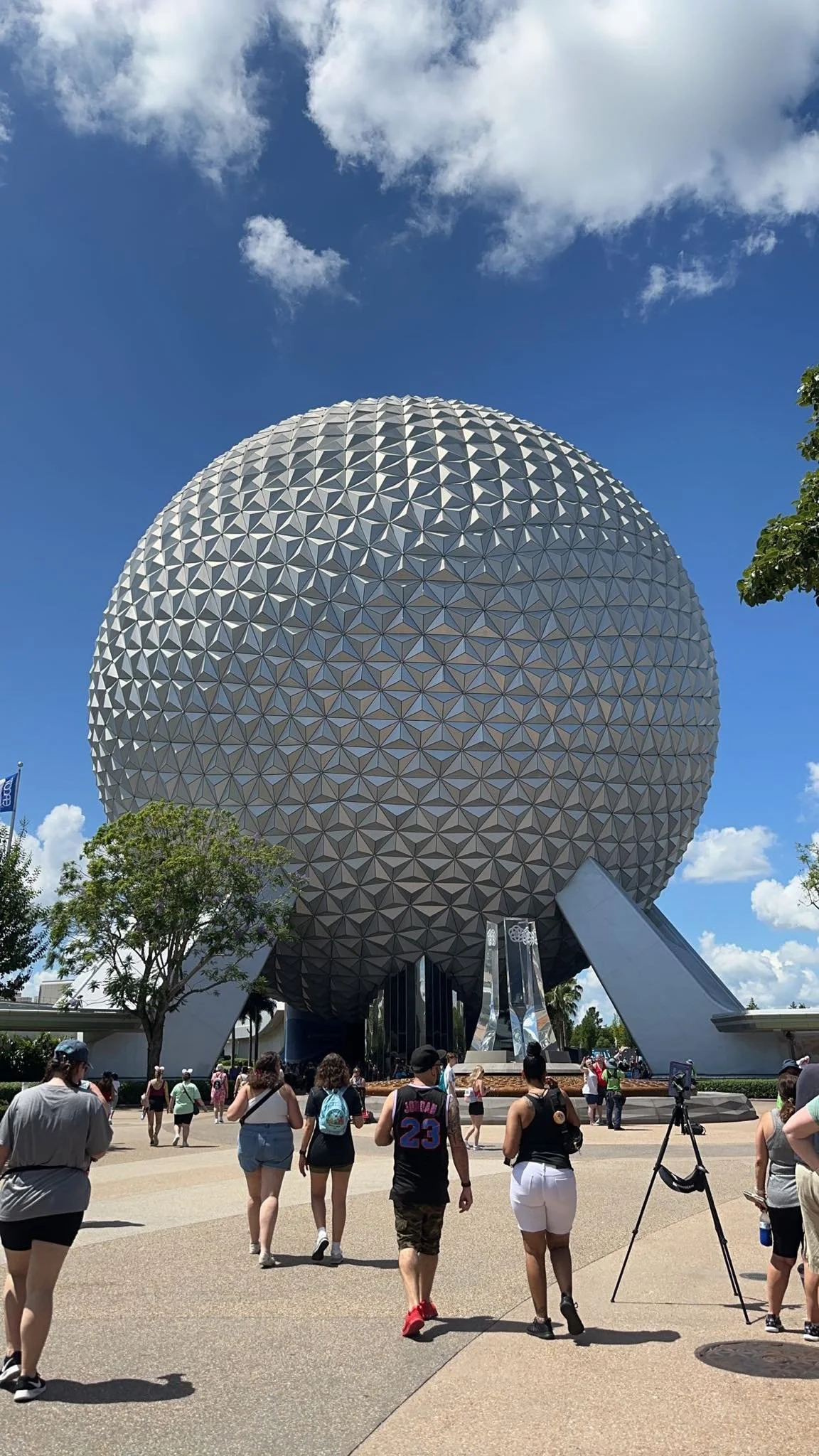 Spaceship Earth at EPCOT, Disney World in Orlando, Florida, with visitors walking around on a sunny day.