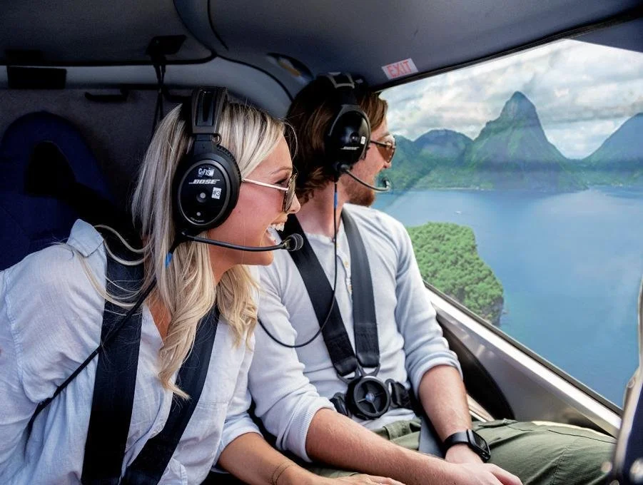 Helicopter soaring above St. Lucia’s lush coastline and iconic Pitons with sweeping aerial views of the Caribbean Sea