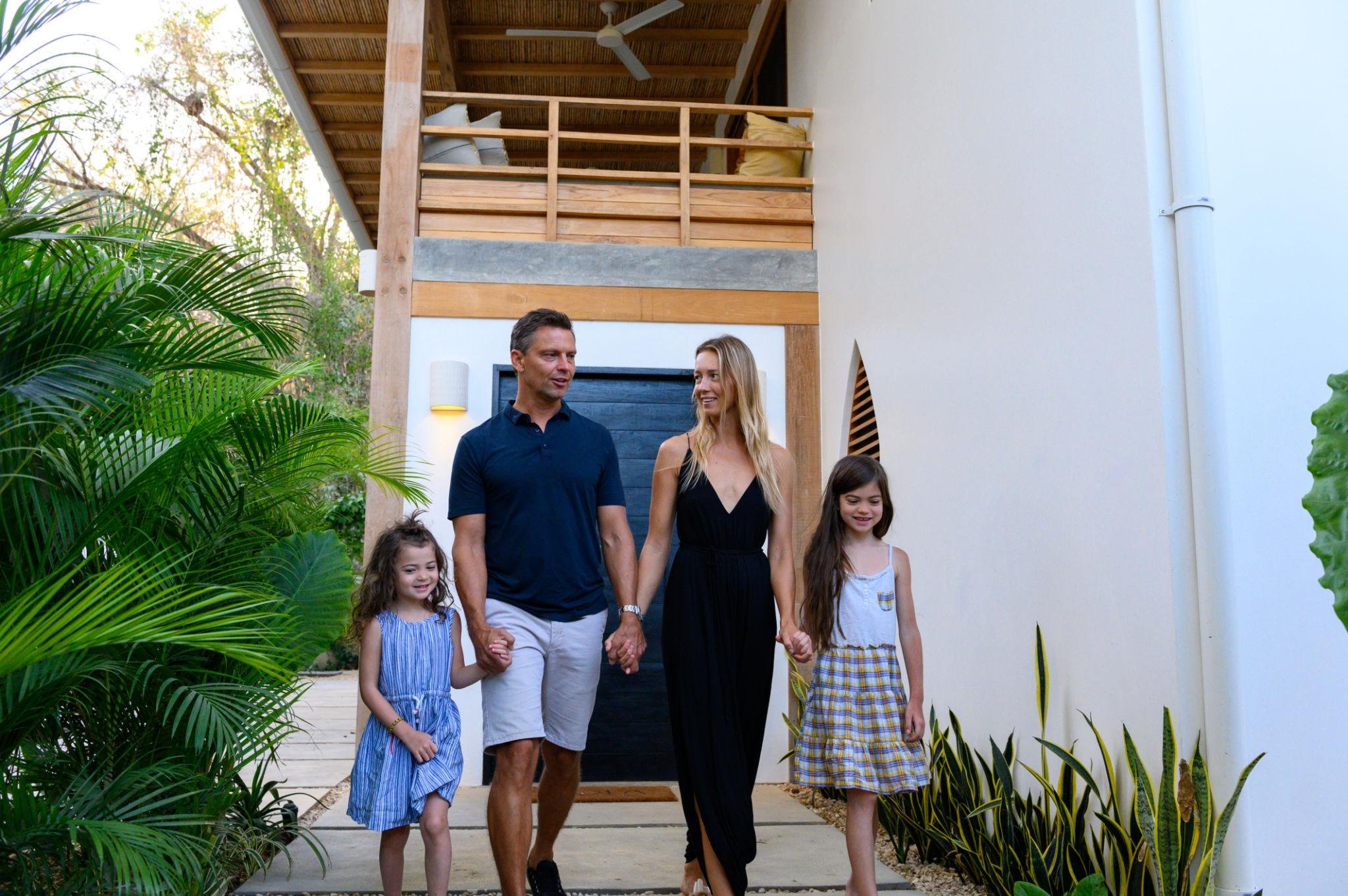 Family of 4 walking through a lux resort