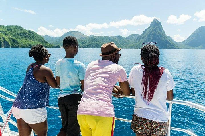 Family enjoying a private catamaran charter near St. Lucia’s iconic Pitons along the Caribbean coastline