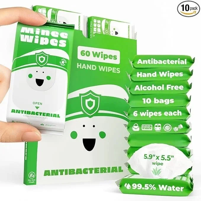 Box of 60 antibacterial hand wipes in a green and white package with smiling face design, displays 10 packs with 6 wipes each, alcohol-free, and 99.5% water content.