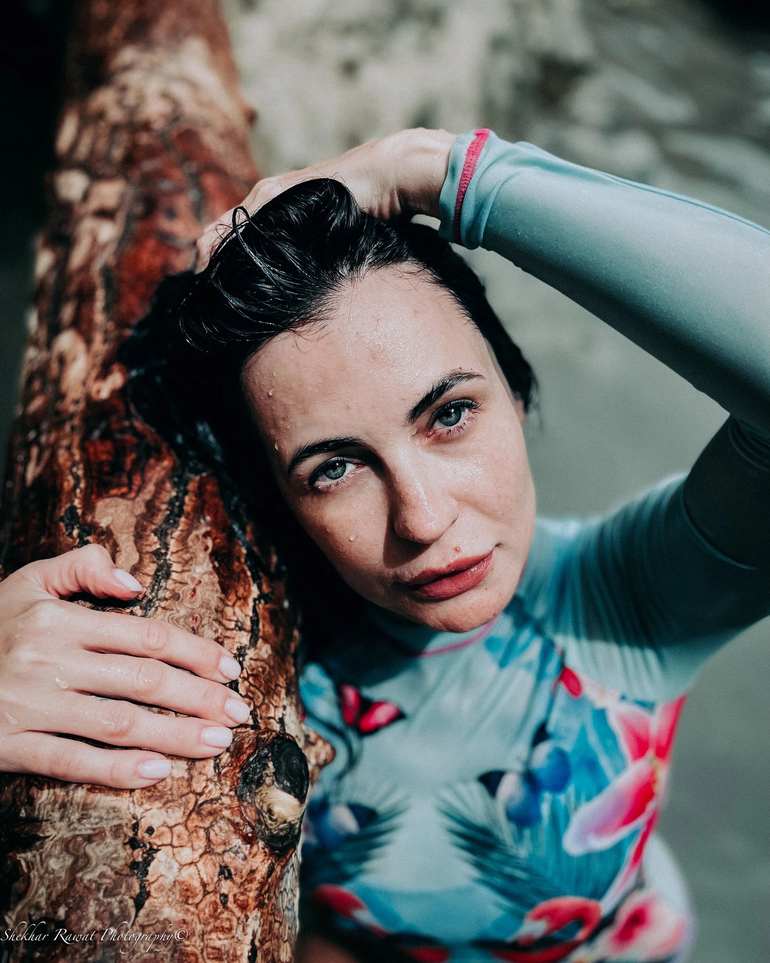 Model with wet hair resting on a patterned pillow, intimate editorial portrait by Melbourne photographer Shekhar Rawat